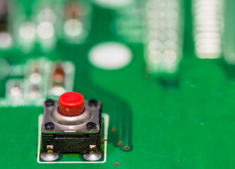 Red button on green circuit board