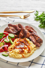 Pork ribs served with mashed potatoes and salad
