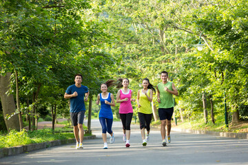 Group of friends running together outdoors