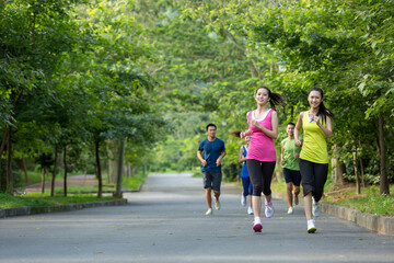 Group of friends running together outdoors