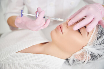 Obraz na płótnie Canvas Aesthetic facial treatment provided by cosmetic master