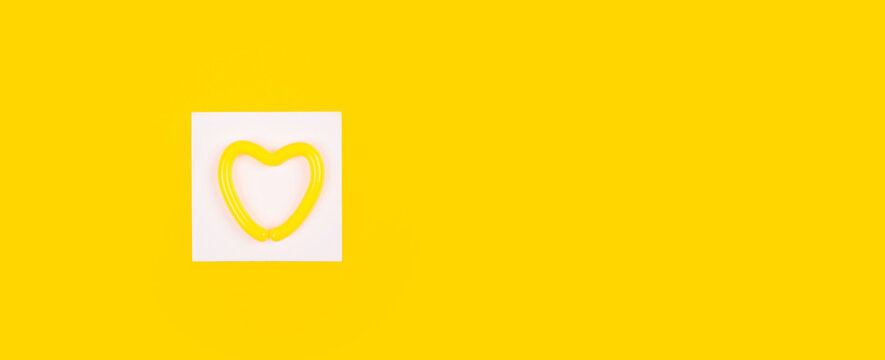 Heart in a white square on a yellow background. Layout for advertising on the topic of relationships, health, medicine, lifestyle or sports. Painting as a bright accent of the interior.
