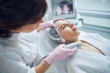 Relaxed charming woman getting skin care treatment