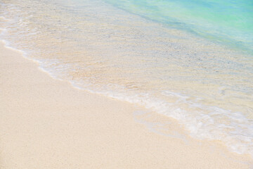Fototapeta na wymiar Wave of blue ocean on sandy white beach. texture Background.