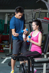 Fototapeta na wymiar Professional fitness coach training fit woman in the gym