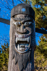 Carved face of wooden totem pole