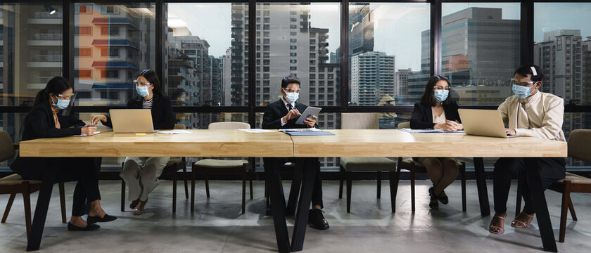 new normal practise businesspeople wear mask and keep social distance