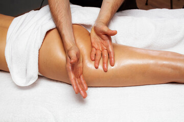 Fototapeta na wymiar Anti-cellulite massage of the thighs close up photo.
