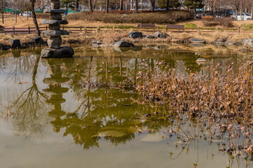 Fototapeta na wymiar Stone tower in small pond