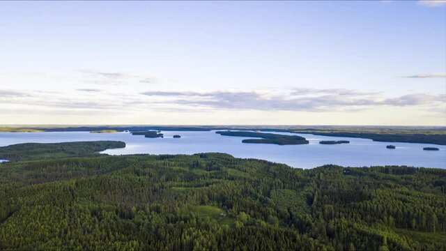Scenic rural landscape hyper/time lapse video over the forest and lake with sunshine. Lake Pyhäjärvi, Finland.