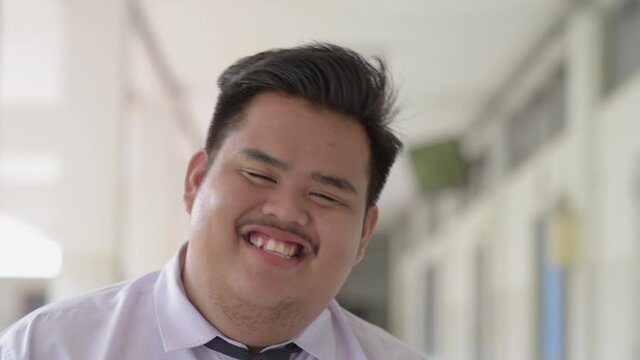 A Fat Asian Man Wearing An Office Suit, Wearing A Necktie And A White Shirt, Laughing, Good-humored,