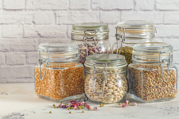 Glass jars with various legumes - beans, mung bean, peas and len