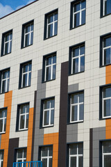 facade of a modern building on a bright Sunny day, siding and Windows, beautiful exterior of the new building