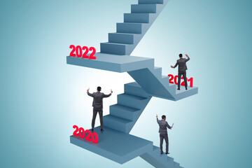 Fototapeta premium Businessman climbing stairs on yearly basis