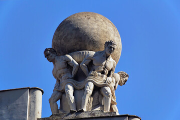 A three strong men holding Earth, bas relief sculpture on the top of the building in Belgrade, Serbia. 