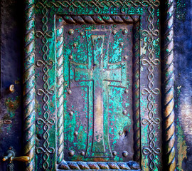 Traditional ornamental decoration at metal entrance door in the church.