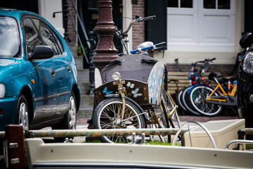 bicycle with a basket for a child, decorated with butterflies, parked on a street in Amsterdam