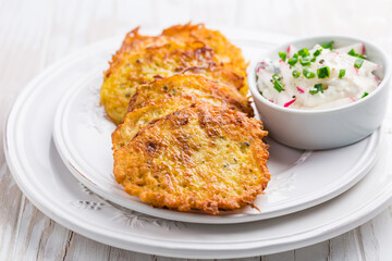 Fried potato pancake with dip of radishes cream cheese and chives