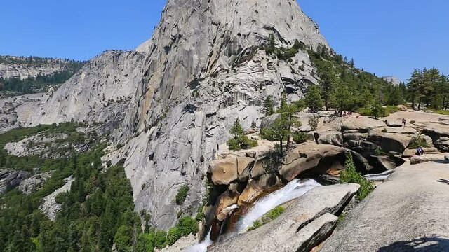 bottom to top view of the Liberty Cap rock and Nevada Fall waterfall on Merced River from John Muir trail in Yosemite National Park. Summer travel holidays in California, United States.