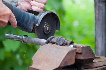 

metal cutting in a vice with an electric grinder