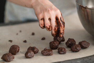 young woman making truffles candy on kitchen