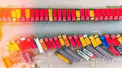 Aerial view of multi-colored dump trucks, trailers, trucks and chassis in the Parking lot for new...