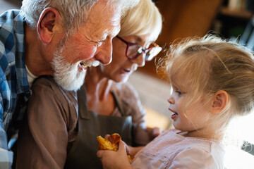Happy grandparents having fun times with children at home