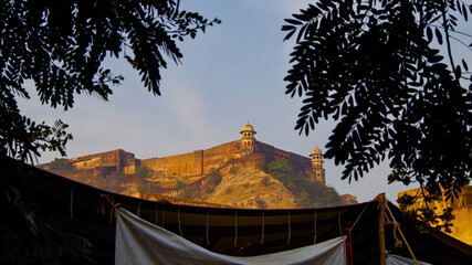 Breathtaking panoramic scenic view of Amber Fort and Palace during morning hours in yellow and...