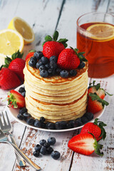 A stack if home-made pancakes with berry