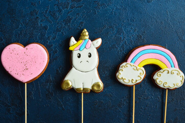 Sweet dessert for children's holiday table. Children's gingerbread in the shape of a unicorn, rainbow and heart with space for text
