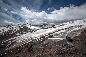 The Caucasus from Elbrus mountains. Snowy peaks under blue sky. Kabardino-Balkaria, Russia.