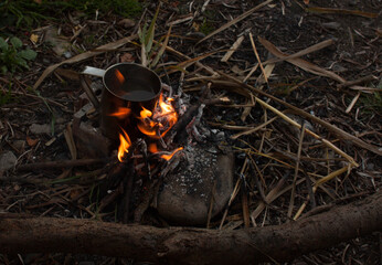 steel cup with cofee cooking on fire