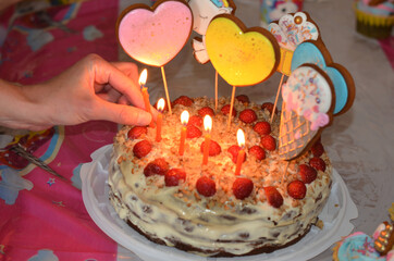 Birthday cake for a child with burning candles