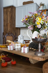 Autumn interior and still life. Pumpkins, apples, zucchini, autumn leaves and flowers. Background. Postcard. Flat lay.