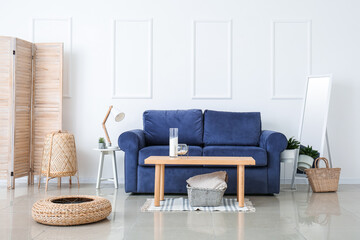 Stylish interior of living room with sofa and table