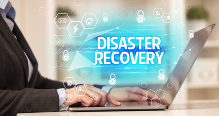 DISASTER RECOVERY inscription on laptop, internet security and data protection concept, blockchain and cybersecurity