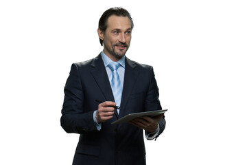 Smiling businessman is writing on the tablet. Successful well-dressed man with pen isolated on white background.