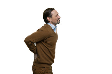 Obraz na płótnie Canvas Middle-aged man touching his lower back. American man with backpain isolated on white background.