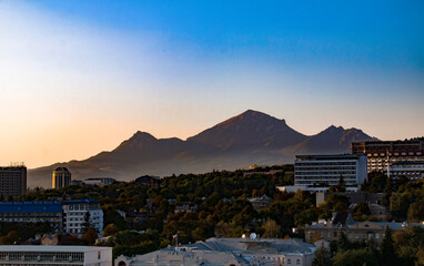 View of colorful sunset over green nature and the city of Pyatigorsk, Russia
