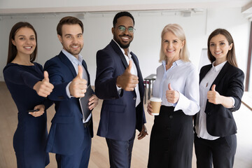 50s and 30s business people corporate team standing in office in line smile look at camera showing thumbs up, positive point of view express good opinion, indication of satisfaction, approval concept