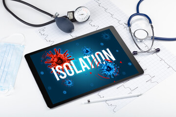 Tablet pc and doctor tools on white surface with ISOLATION inscription, pandemic concept