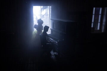 A realistic dollhouse living room with furniture and window at night. Artwork table decoration with handmade realistic dollhouse.