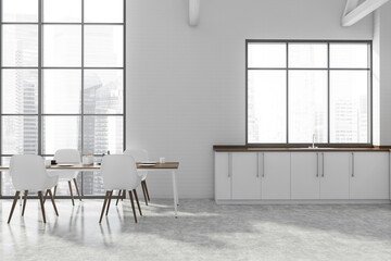 White kitchen with dining table and window