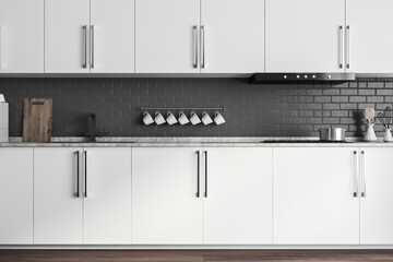 White cabinets in grey brick kitchen