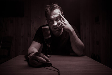 Serious reporter in television studio looking at the camera