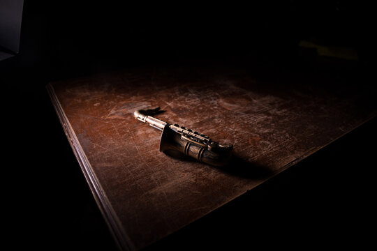 Alto gold sax miniature with colorful toned light on foggy background. Saxophone music instrument in lowlight. Selective focus