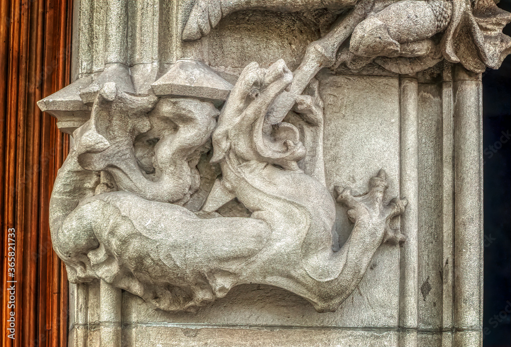 Wall mural bas relief sculpture of a beast, probably dragon, as decorative element on exterior wall in barcelon