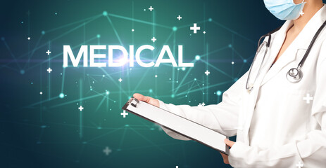 Doctor fills out medical record with MEDICAL inscription, medical concept