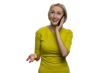 Happy woman talking on phone and gesticulating. Smiling young casual looking up.