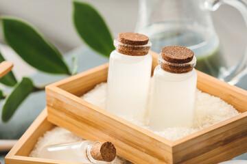 Bottles of rice water on table, closeup
